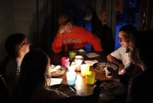 Members of the Ward family, of Wilbraham, Mass., from the left, daughters Melanie and Grace, father Chris, top, son Ben, and mother Tracey, eat dinner by the light of lanterns during a blackout in their Wilbraham home Monday, Oct. 31, 2011. The Wards have been without power since Saturday after snow and high winds from a rare late October storm brought down trees and tree limbs across the state, damaging power lines and leaving many without electricity. (AP Photo/Steven Senne)